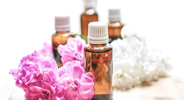 Bottles of Essential Oils and Flowers and How to Understand Aroma Notes in Essential Oils.