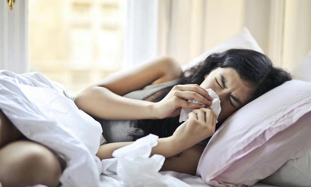 Woman not Feeling Well and Homeopathic Remedies That May Help Symptoms of Cold and Flu.